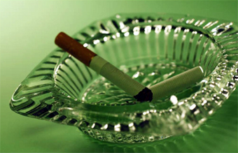 ashtray with lit cigarette